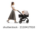 Full length portrait of a mother walking a cute baby boy in a stroller isolated on white background