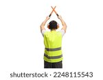 Rear view shot of an marshaller signalling with crossed wands isolated on white background