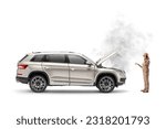 Woman with a broken down car calling a road service company isolated on white background