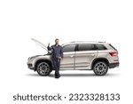 Auto mechanic leaning on a SUV with an open hood and gesturing thumbs up isolated on white background 