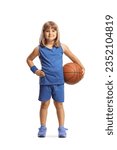 Small photo of Little girl in a blue jersey kit holding a basketball and smiling isolated on white background