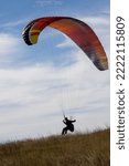 Small photo of Ferryland, Newfoundland and Labrador, Canada - October 15, 2022: A paraglider taking advantage of the steady ocean winds moving upslope on the outskirts of the coastal town of Ferryland.