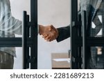 Small photo of Close-up cropped shot of unrecognizable business partners shaking hands agree to deal or say hello at office. Two businessmen handshaking after successful project. Success, dealing, greeting concept.
