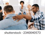 Small photo of Closeup back view of unrecognizable sad man sharing life problem grief with multiracial people in modern mental health support group session in rehab center. Concept of mental health, psychotherapy.