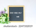 Small photo of Letter board with phrase Good vibes only white background, flowers with heart. Concept of mental health. Aspiration, supportive sentence, law of attractions, affirmatives, subconscious mind, NLP.