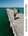 Small photo of MELBOURNE/AUSTRALIA - FEBRUARY 6: Locals fishing on the jetty in Mordialloc which is a coastal suburb of Melbourne, Ausralia.