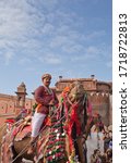 Small photo of BIKANER, RAJASTHAN, INDIA - JANUARY 11, 2020: Indian boy riding on camel during Camel festival in Rajasthan. The Camel Festival begins with a colourful procession of bedecked camels.