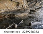 Cave With Icy Water And Logs