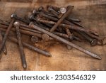 Small photo of old rusty, 16 penny nails, pile of heavy penny nails for construction and carpentry, building, creating, antique, old, grandfathers building tools