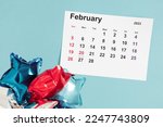 President's Day. Date on calendar February 20, 2023. Red, blue and white star balloon, decorations on blue background. Happy Presidents Day, calendar. Flat lay, top view, copy space