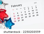 President's Day. Date on calendar February 20, 2023. Red, blue and white star balloon, decorations on white background. Happy Presidents Day, calendar. Flat lay, top view, copy space