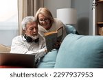 Small photo of Simple living. Happy middle-aged senior couple 70s husband and wife sit relax on couch in living room reading book drinking tea together, calm elderly 60s couple booklovers rest at home enjoy life