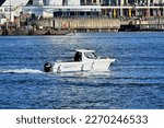 Small photo of Portsmouth Harbour, Hampshire, England. February 14th 2023. Colour. A small boat, Old Buoys 2, a Quicksilver 640 vessel, passing Gunwharf Quays.