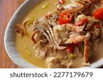 Small photo of Crab curry recipe with pork and red chilis thai style. Local name is Lon Pu. Crabs with pork and herbs simmer down in coconut milk.