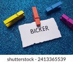 Small photo of Bicker writting on blue background.
