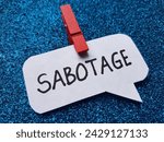 Small photo of Sabotage writting on blue background.