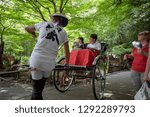 Small photo of Hokkaido Japan - 10 Aug 2015 : Jinrikisha or Japanese rickshaw driven by male driver carrying tourist for sightseeing in Arashiyama, Kyoto in Japan