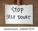Small photo of Handwritten message paper STOP SELF DOUBT, concept of self worth , stop striving for approval, more valid , more loved or validation , you are good enough