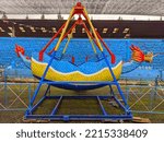 Small photo of Wonosobo, Indonesia - October 16, 2022: Game rides in Indonesia called Kora Kora with the dragon shape in an amusement park