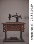 Small photo of miniature sewing machine, this is an example of a manual sewing machine. Manual sewing machines are an ancient type of sewing machine that can be operated without using electricity.