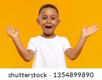 I’m so happy. Picture of overjoyed excited black little boy of African origin exclaiming emotionally and gesturing actively with both hands, amazed with good news, receiving highest mark for test