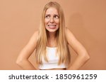 Small photo of Embarrassment, awkwardness and puzzlement concept. Isolated shot of stylish cute young woman with teeth brackets looking away with embarrassed shy smile because of uncomfortable question or joke