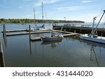 Small photo of View of the dockage at Belfast Maine with sailboats and a mooring barge.