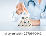 Small photo of Hand Arranging Wood block With Health medical icon health insurance concept.