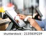 Small photo of Concept of small business or sevice, woman or saleswoman in apron at counter with cashbox working at clothes shop, touchscreen POS, finance concept, business