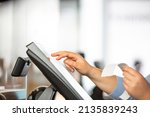 Small photo of Concept of small business or sevice, woman or saleswoman in apron at counter with a cashbox working at clothes shop, touchscreen POS, finance concept, business