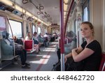 Woman travels overground metro in the afternoon in Canada