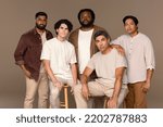 Small photo of Three quarter length studio portrait of five hansom men from diverse ethnic backgrounds posed confidently on a neutral background