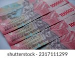 Small photo of Indonesian currency as known mata uang rupiah, one hundred thousand rupiah denomination with sequential serial number.