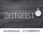 zeitgeist word written on chalkboard with vintage precise stopwatch