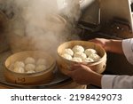 Small photo of Image of making process of Chinese traditional food - baozi ( Chinese steamed buns ). Using a rolling pin and flatten the dough into a round thin wrapper approx.