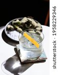 Small photo of Clea Tequila and Grapefruit Old Fashioned Cocktail with clear Ice, fresh green Almonds and Salt