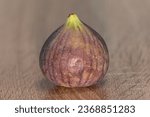 Small photo of Fresh and ripe fig on a wood background,single fig,fig fruit fresh figs,food background