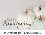 White minimalism pumpkins with happy thanksgiving message for holiday.