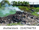 Small photo of Garbage pollution from small towns Incinerated and disposed of incorrectly A source of pollution And spread the disease.Smoke of burning garbage into the air- pollution from waste garbage .