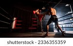 Small photo of Asian and Caucasian Muay Thai boxer unleash knee attack in fierce boxing training session, delivering knee strike to sparring trainer, showcasing Muay Thai boxing technique and skill. Spur