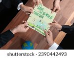 Small photo of Cohesive group of business people forming jigsaw puzzle pieces in environmental awareness symbol as eco corporate responsibility for community and sustainable solution for greener Earth. Quaint