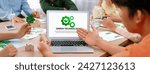Small photo of Green technology logo displayed on green business laptop while business team presenting green design to customer. ESG environment social governance and Eco conservative concept. Closeup. Delineation