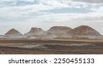 Small photo of Landscape scenic view of desolate barren western desert in Panoramic barren landscape in Egypt Western White desert with geological rock formations