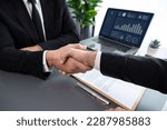Small photo of Two professionals successfully close business deal with closeup handshake, sealing the partnership agreement. Legal document and handshaking as formal agreement between two companies. Fervent