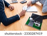Small photo of Client and real estate agent review loan contract, discussing term, interest rate, and property ownership. Analyze legal document and thoroughly read agreement before making decision. Entity