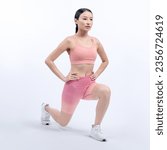 Small photo of Young attractive asian woman in sportswear stretching before fitness exercise routine. Healthy body care workout with athletic woman warming up on studio shot isolated background. Vigorous