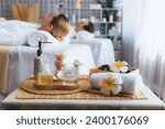 Small photo of Aromatherapy massage on daylight ambiance or spa salon composition setup with focus decor and spa accessories on blur woman enjoying blissful aroma spa massage in resort or hotel background. Quiescent