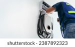 Small photo of Certified male Electrician Installing Home EV Charger