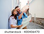 Couple of tourists sightseeing old european  town with map