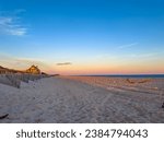 Small photo of Kilkare mansion at sunset, historic oceanfront home in Wainscott, East Hampton, New York. Sand dunes, empty beach.